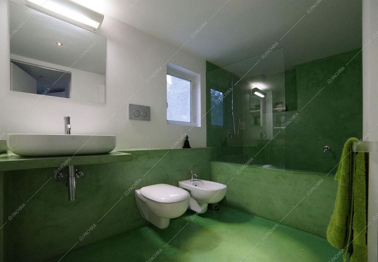 Bagno verde con sanitari sospesi, box doccia e vasca da bagno combinate