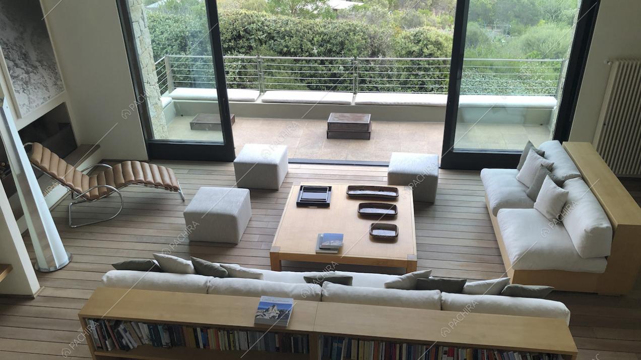 Soggiorno con divani, pouf, pavimento in parquet e terrazza