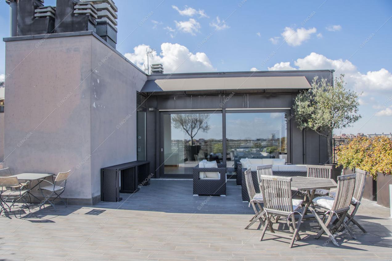 Terrazza con tavoli da pranzo e divano da esterno