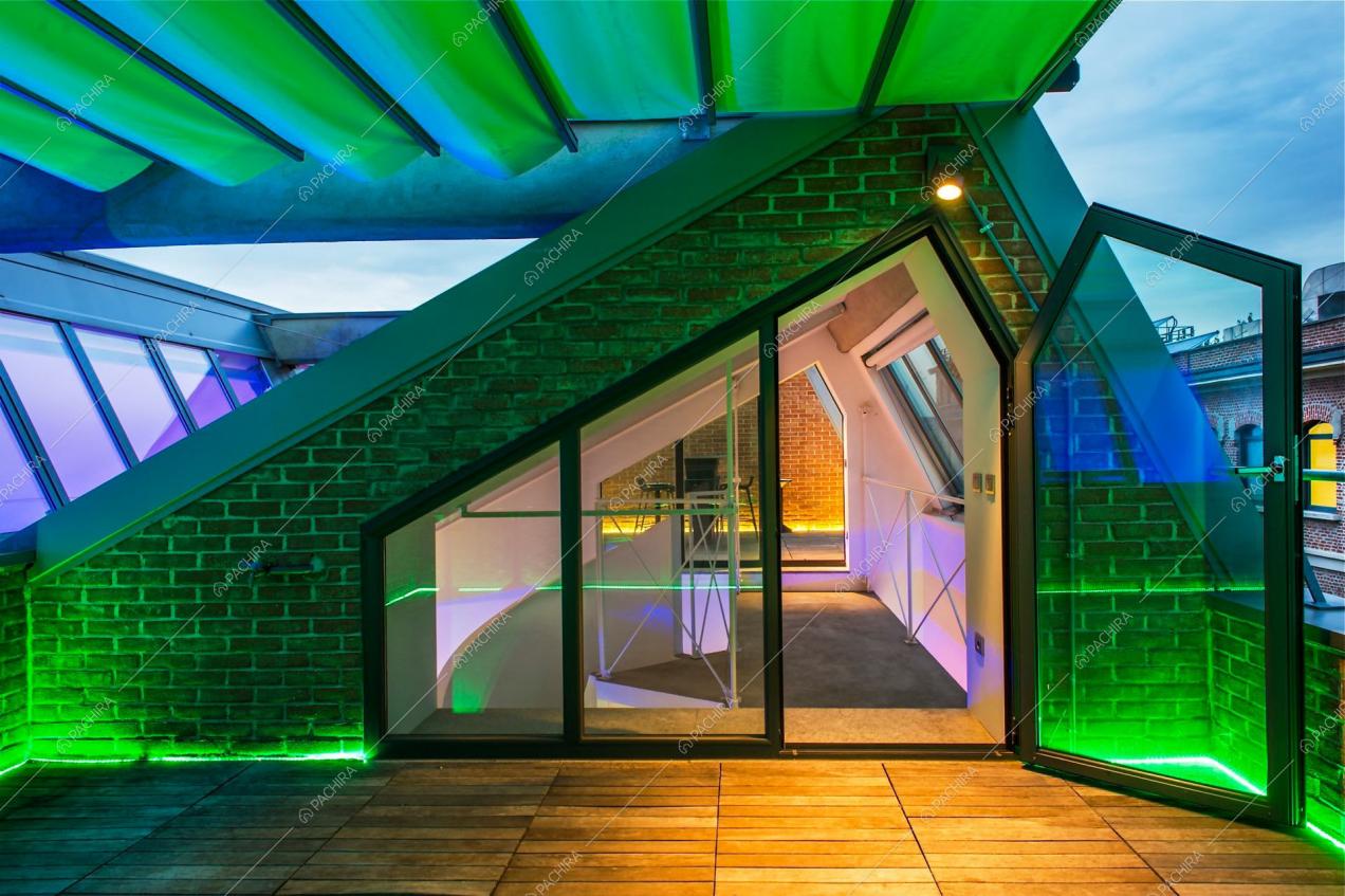Terrazza con pavimento in parquet da esterno e parete in mattoni