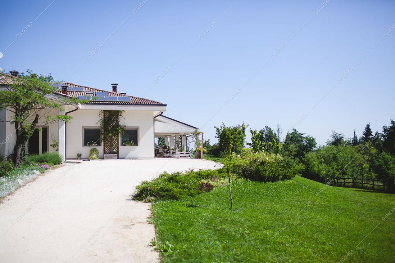 Vista della villa dalla strada di accesso e giardino