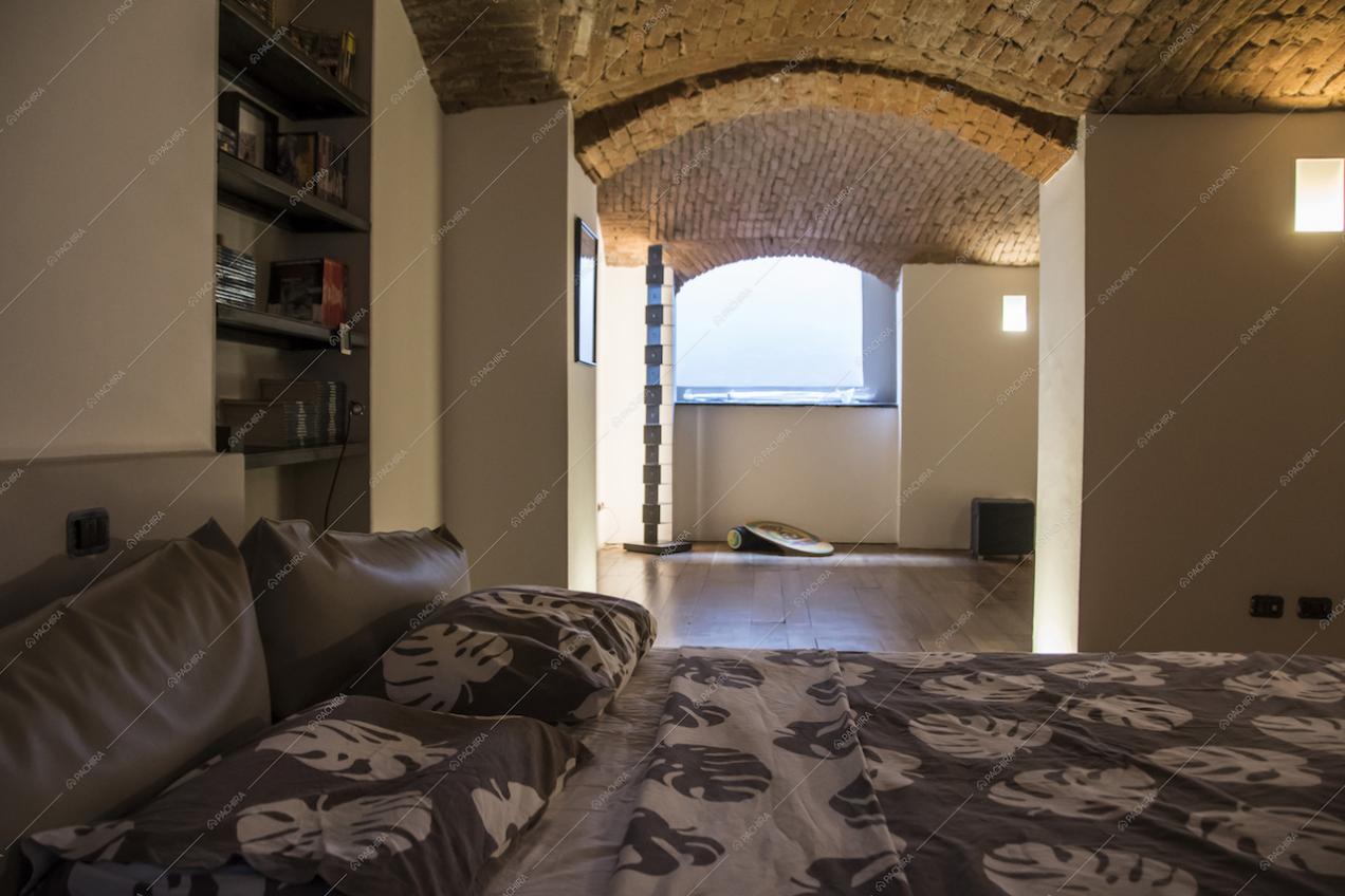 La camera da letto della location Carota con il soffitto a volte
