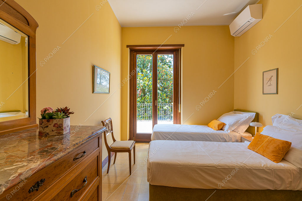 Camera da letto con pareti gialle della villa Ramaria, location in stile classico a Ravenna