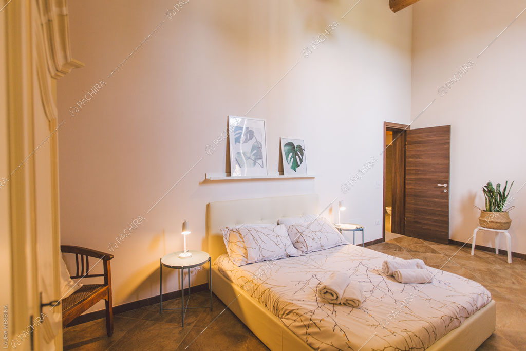 Letto matrimoniale nella camera della villa Hibiki, location in stile moderno a Siracusa