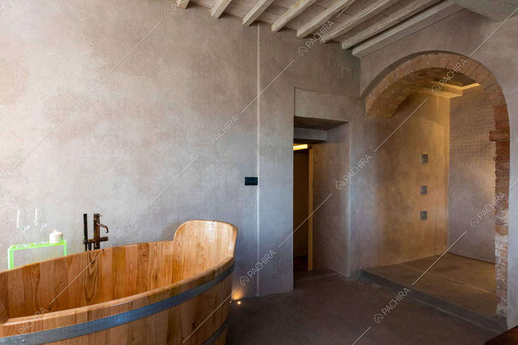 Pareti grigie e vasca in legno nella spa della villa Bardenas, location in stile rustico a Siena