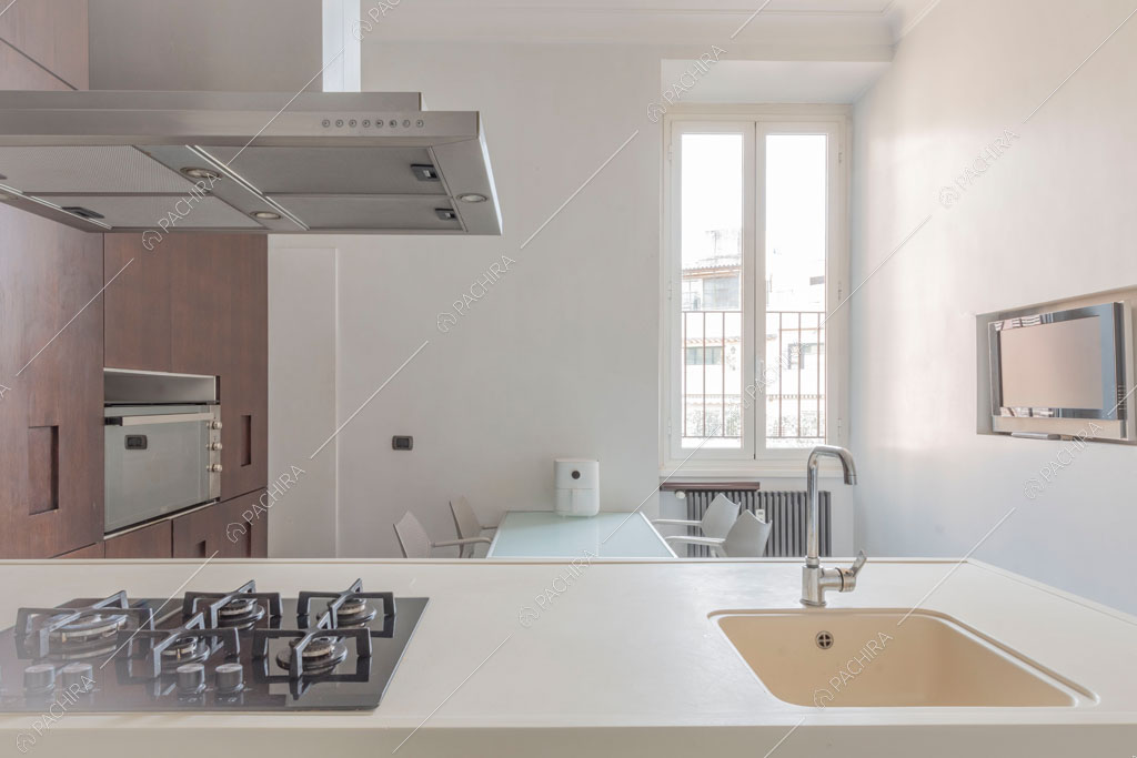 Fornelli a gas sulla penisola della cucina dell'appartamento Kiwano, location in stile moderno a Roma