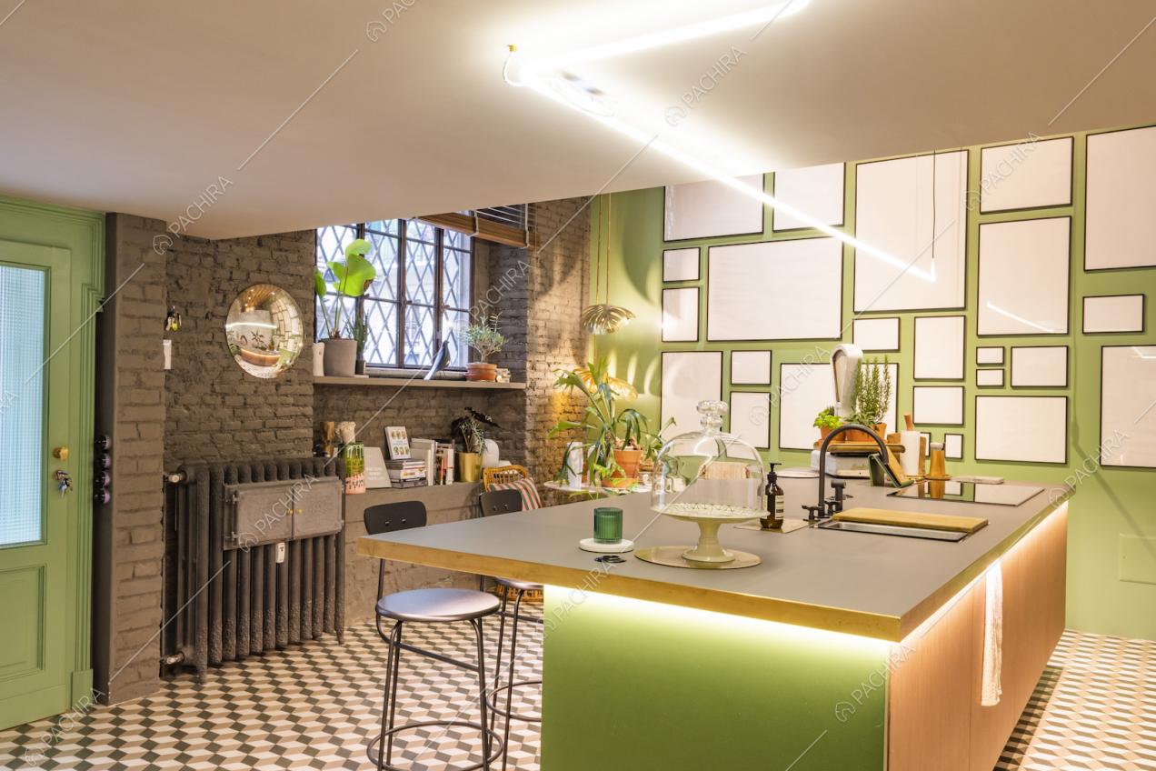 Cucina a vista con sgabelli, mattoni a vista e arredi di design