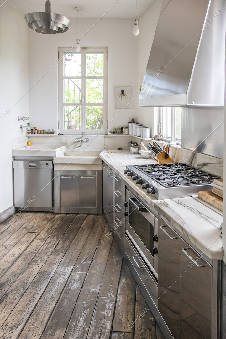Cucina a parete in acciaio e pavimento in legno